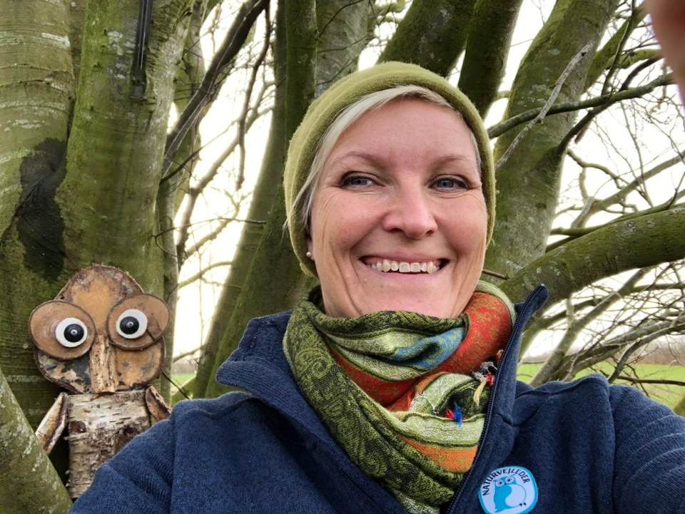 Billede af Karin, sammen med en ugle-figur af træ